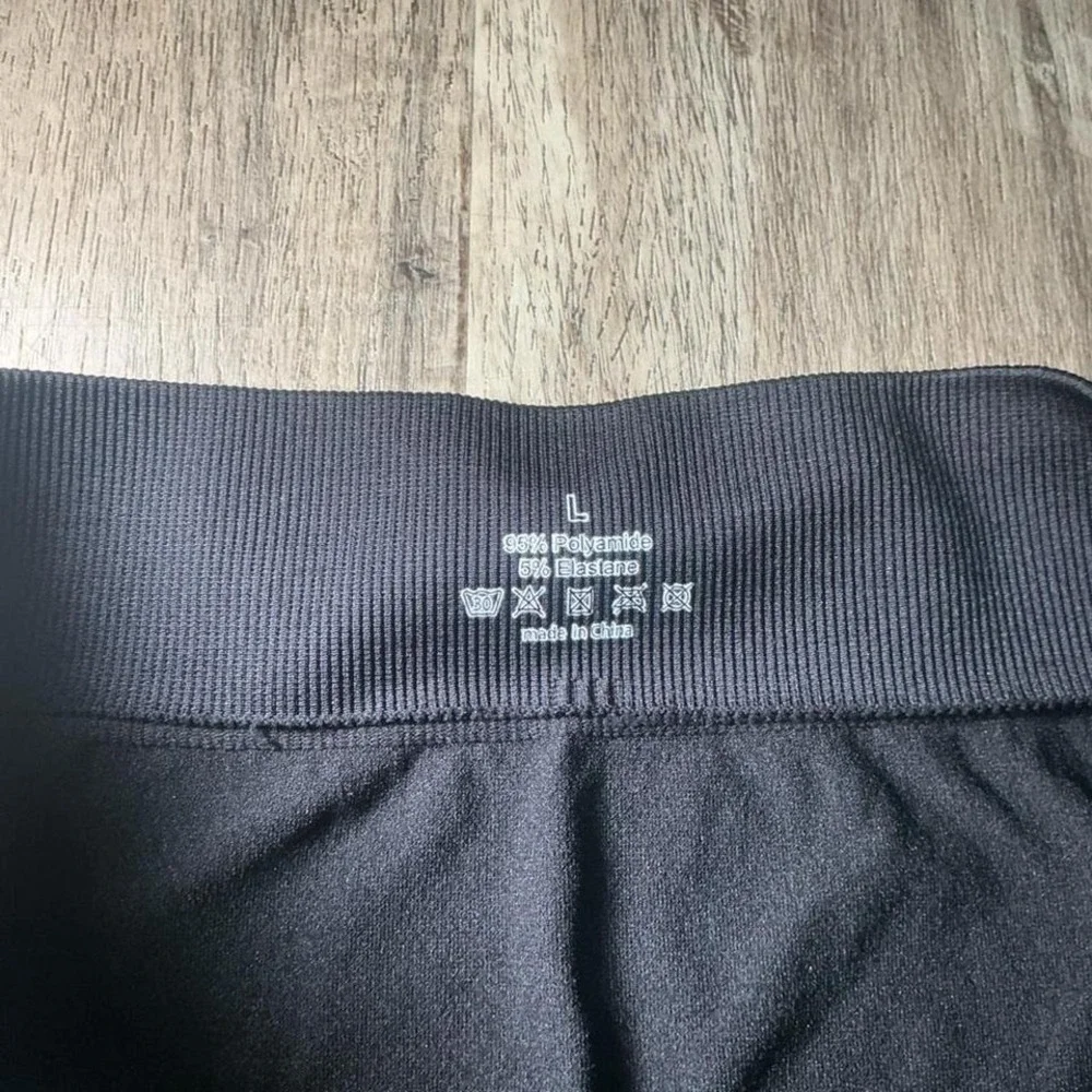 Black & multi-coloured star print bike shorts in a size L